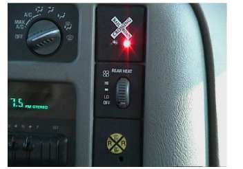 Figure 83. In-Vehicle Display. This is an image of a car interior instrument panel with a railroad crossing alert light illuminated.